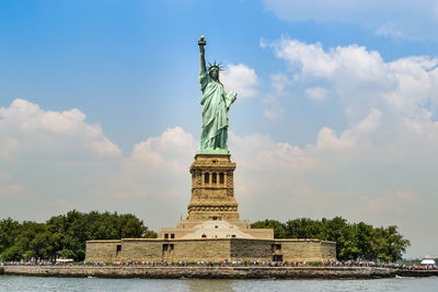 Low angle view of statue against cloudy sky