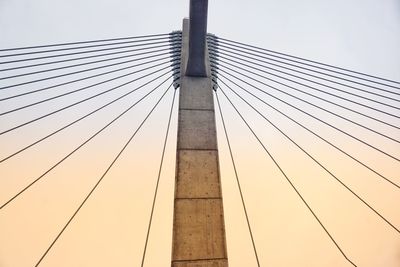 Low angle view of suspension bridge against sky