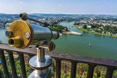 Close-up of coin-operated binoculars against cityscape