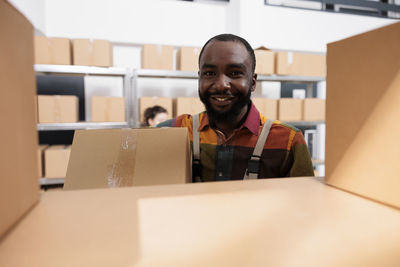 Portrait of young man holding box