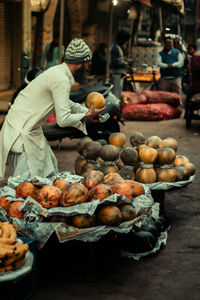 Midsection of woman holding fruits for sale at market