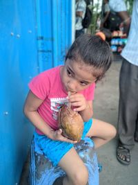 High angle view of girl drinking from coconut