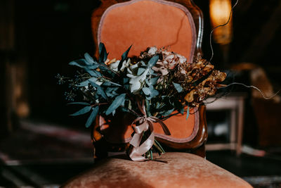 Close-up of woman with flowers in vase