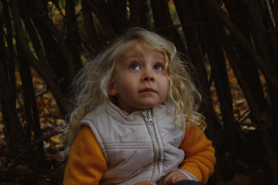 Portrait of cute baby girl in forest