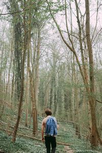 Rear view of a man walking in forest