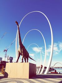 Low angle view of statue against clear blue sky