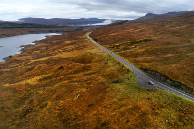High angle view of road amidst land against sky in scotland