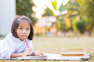 Portrait of a smiling girl sitting on table