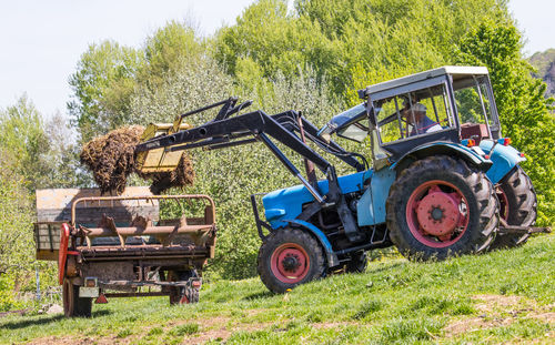 Tractor loading mud in truck