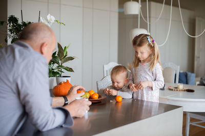 Grandfather with children at home