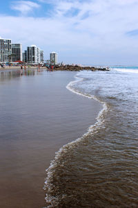 Scenic view of sea against cloudy sky