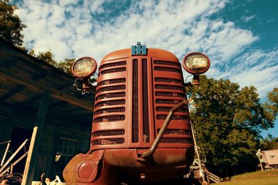 Low angle view of old machinery against sky