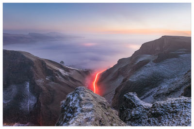 Dramatic cloud inversion over castleton in the peak district at sunrise.