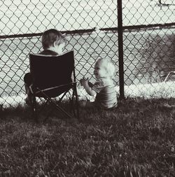 Rear view of couple sitting on grass