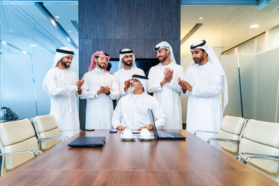 Portrait of female friends standing in office