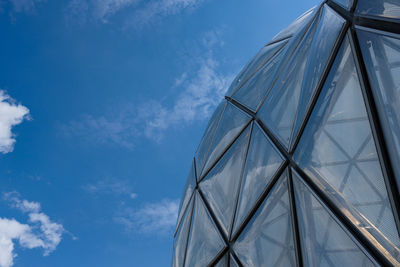 Low angle view of modern building against blue sky