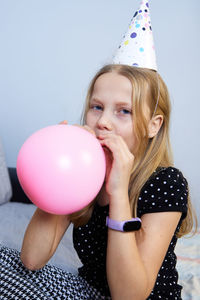 Children have fun playing, blowing up colorful balloons, at a birthday party