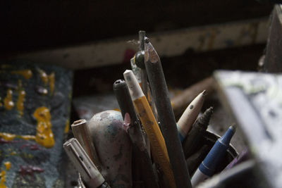 Close-up of old felt tip pens and colored pencil in desk organizer on table