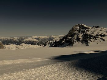 Scenic view of snowcapped mountains against clear sky