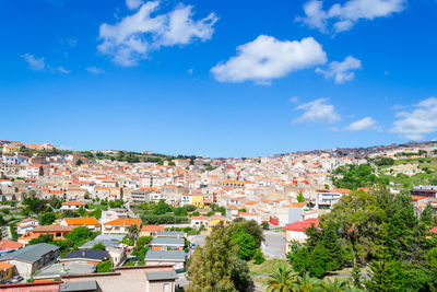 High angle view of townscape against blue sky