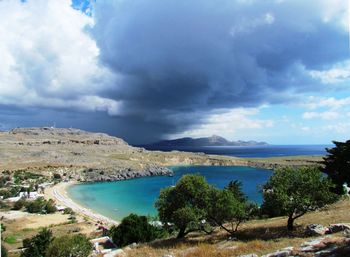 Scenic view of sea and mountains against sky