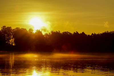 Scenic view of calm lake at sunset