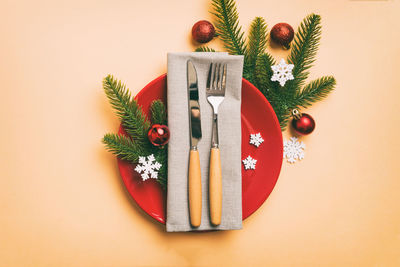 High angle view of christmas decorations on pink background