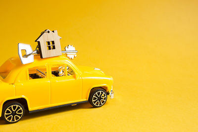 Toy car on yellow background