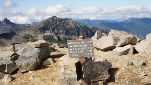 Text on rocks against mountains