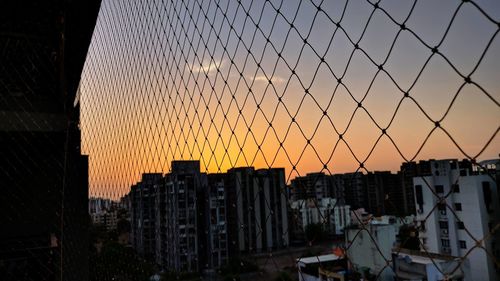 Buildings in city during sunset