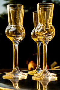 Close-up of wineglass on table against black background