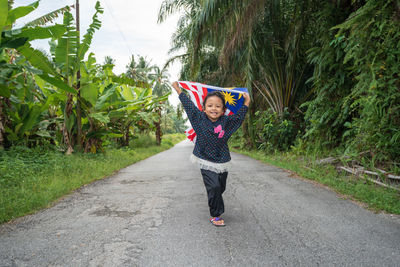 Full length of woman walking on road