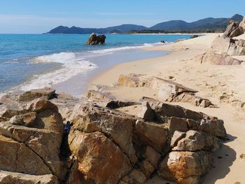 View of rocks on beach against sky