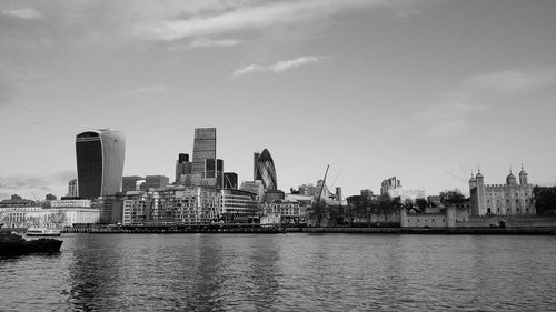 View of calm sea with cityscape in background