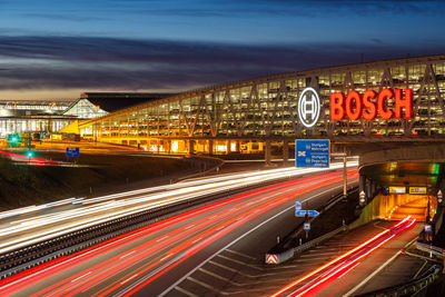 Light trails on road against sky at night