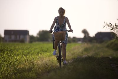 Side view of man riding bicycle on field