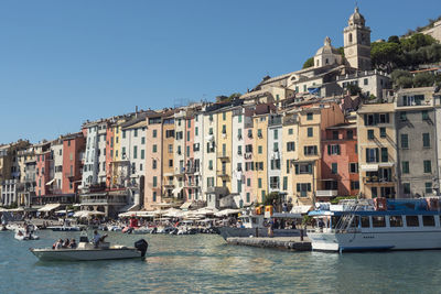 Boats in sea against clear sky