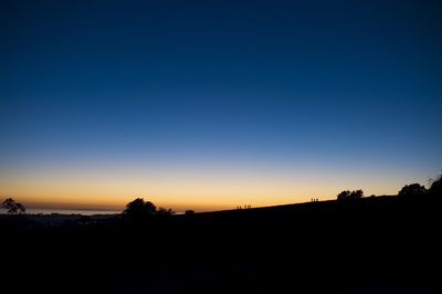 Silhouette of trees against sky at sunset