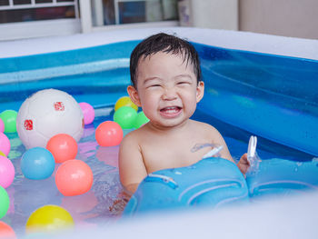 Portrait of happy baby boy swimming in pool