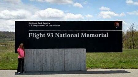 Information sign against cloudy sky