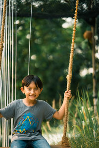 Portrait of boy on swing