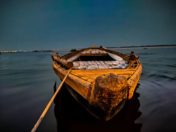 Boat moored in sea against clear sky