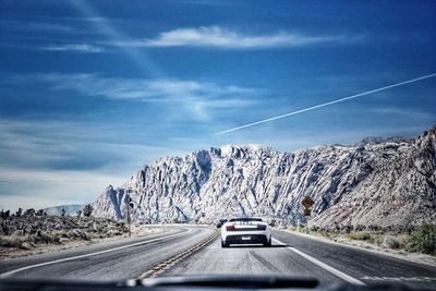 Cars on road against sky