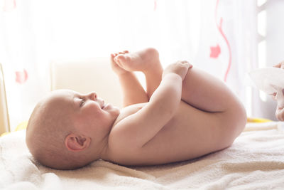 Cute baby lying on bed
