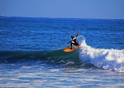 People surfing in sea
