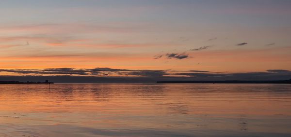 Scenic view of lake against romantic sky at sunset