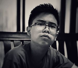 Close-up portrait of boy sitting on chair