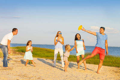 People on beach against sky