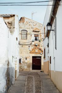 Narrow alley amidst buildings in city