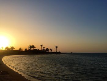 Scenic view of sea against clear sky during sunset